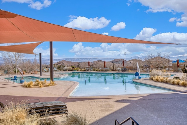 view of swimming pool featuring a mountain view and a patio