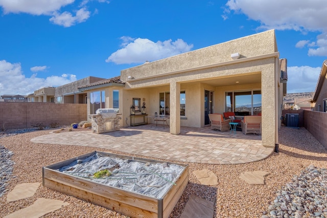 back of house with an outdoor living space and a patio area