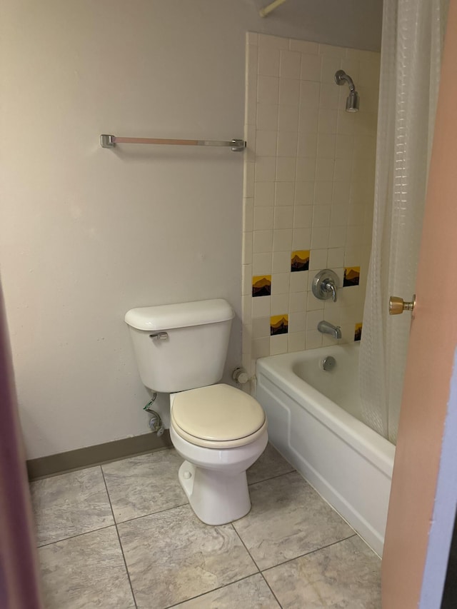 bathroom featuring toilet, tile patterned floors, and shower / tub combo with curtain