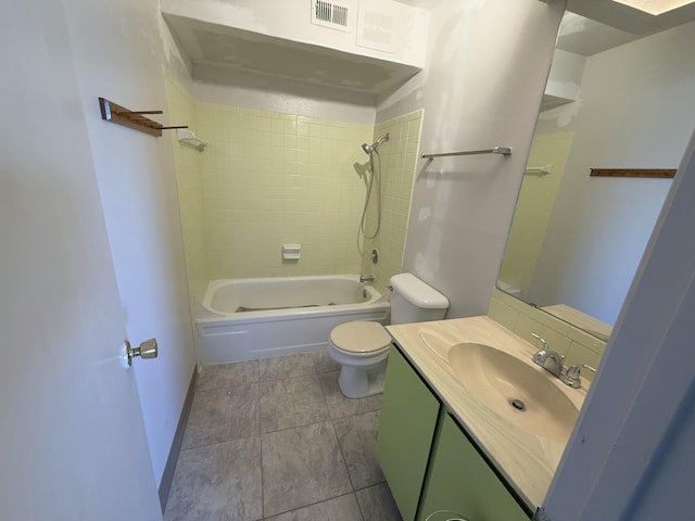 full bathroom featuring toilet, tiled shower / bath combo, and vanity