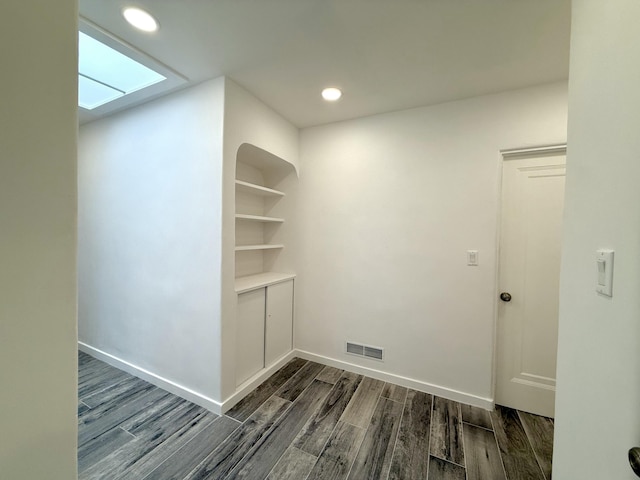 clothes washing area featuring dark wood-type flooring