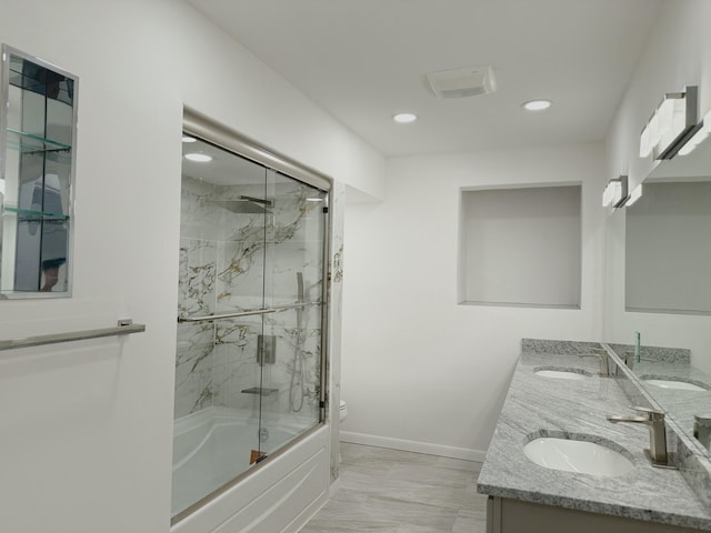 bathroom featuring vanity and bath / shower combo with glass door