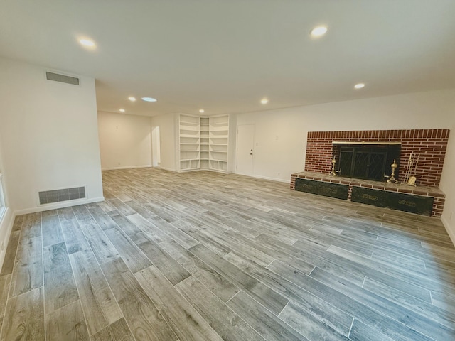 unfurnished living room featuring a fireplace and light wood-type flooring