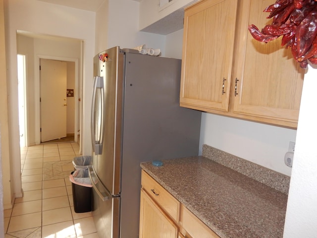 6456 Ja Ct NW, Albuquerque, NM 87120 - kitchen with light brown cabinetry, freestanding refrigerator, and light tile patterned flooring