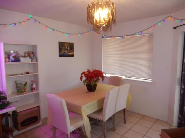 6456 Ja Ct NW, Albuquerque, NM 87120 - dining space featuring a chandelier and light tile patterned floors
