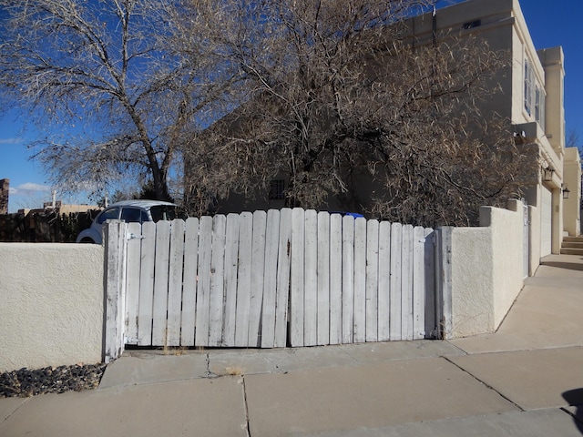 6456 Ja Ct NW, Albuquerque, NM 87120 - view of property exterior featuring a gate and stucco siding