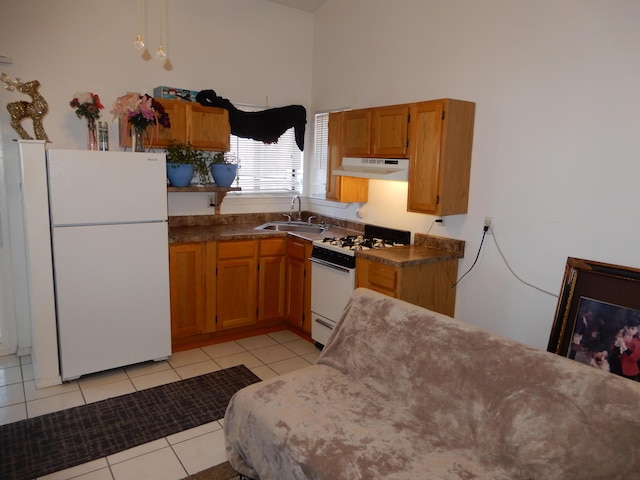 6456 Ja Ct NW, Albuquerque, NM 87120 - kitchen with white appliances, under cabinet range hood, light tile patterned floors, brown cabinetry, and dark countertops
