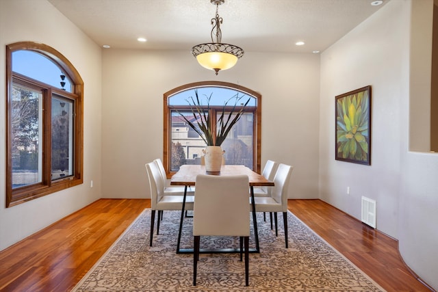 dining room featuring recessed lighting, visible vents, a textured ceiling, and wood finished floors