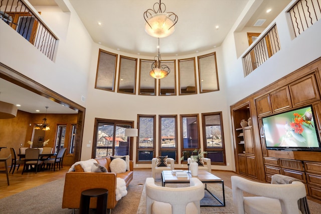 living area with recessed lighting and a high ceiling