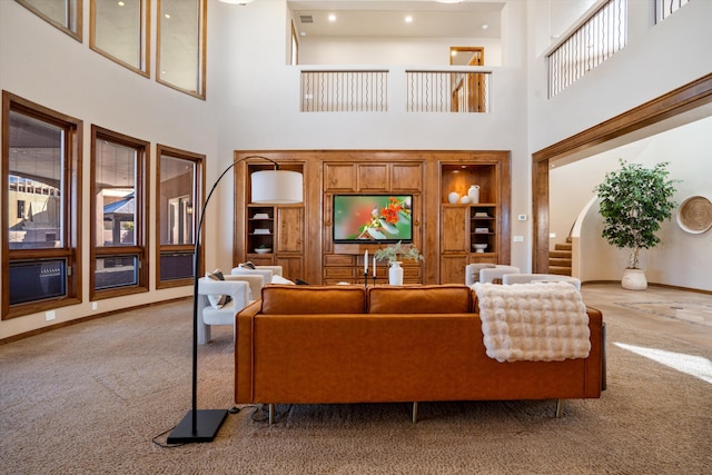 living room with baseboards, visible vents, built in features, stairs, and carpet floors