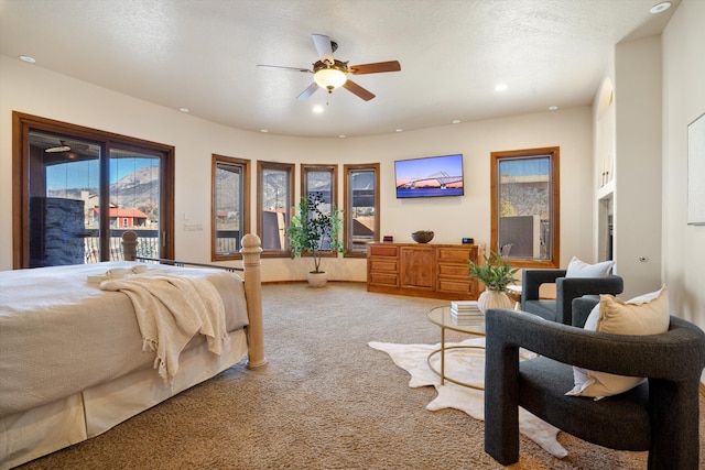 bedroom with light colored carpet, ceiling fan, access to exterior, a textured ceiling, and recessed lighting