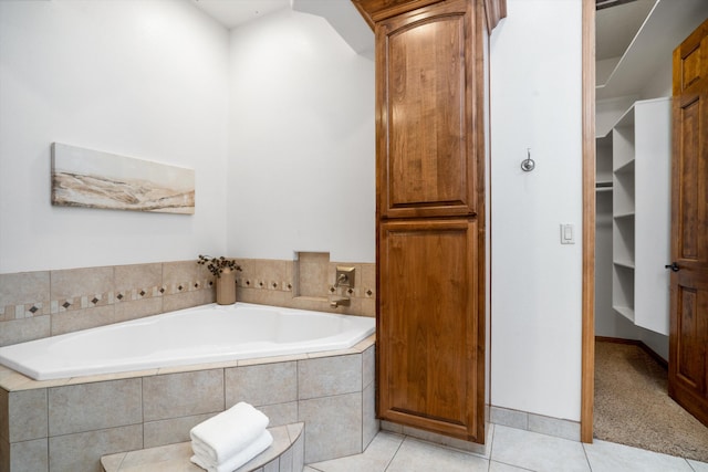 full bathroom with a garden tub and tile patterned floors