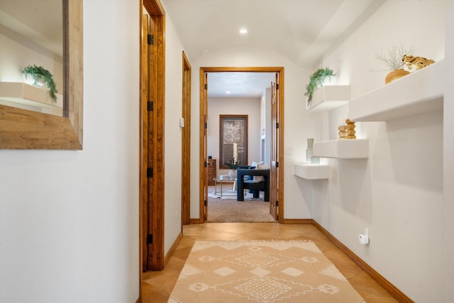 hall featuring light tile patterned floors, baseboards, and recessed lighting