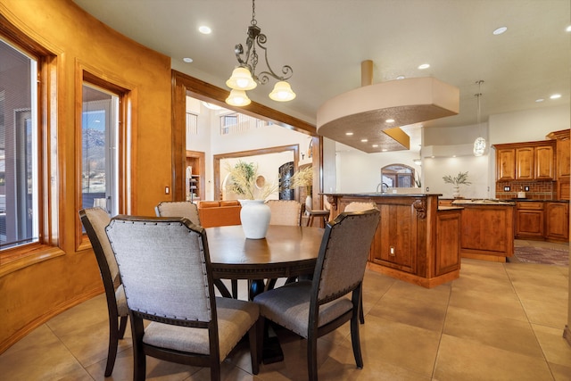 dining room with light tile patterned flooring, an inviting chandelier, and recessed lighting