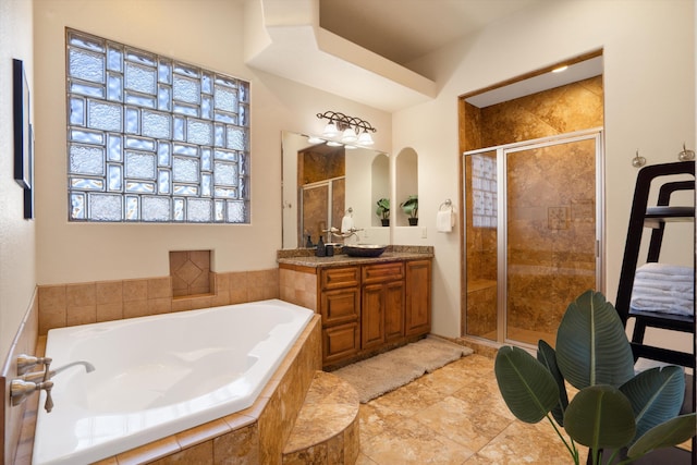 full bath with a shower stall, a bath, and vanity