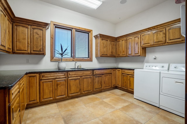 laundry area featuring cabinet space, independent washer and dryer, a sink, and light tile patterned flooring