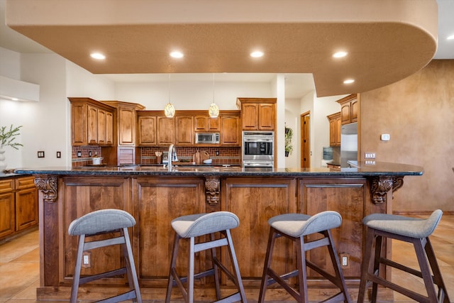 kitchen with brown cabinetry, tasteful backsplash, stainless steel appliances, and recessed lighting