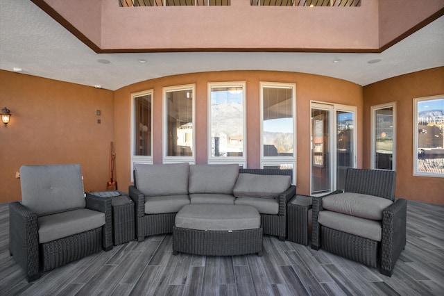 wooden deck with an outdoor living space