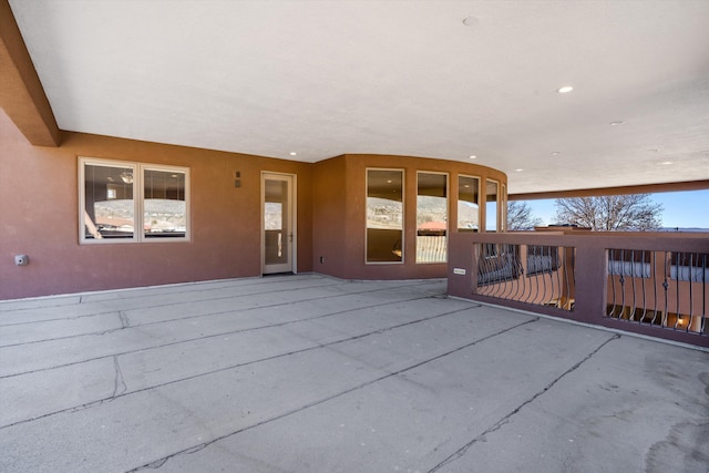 doorway to property with a patio area and stucco siding