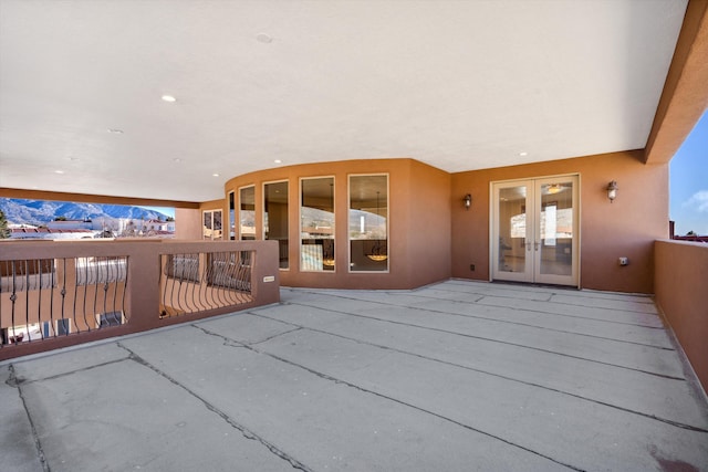 view of patio featuring a balcony and french doors