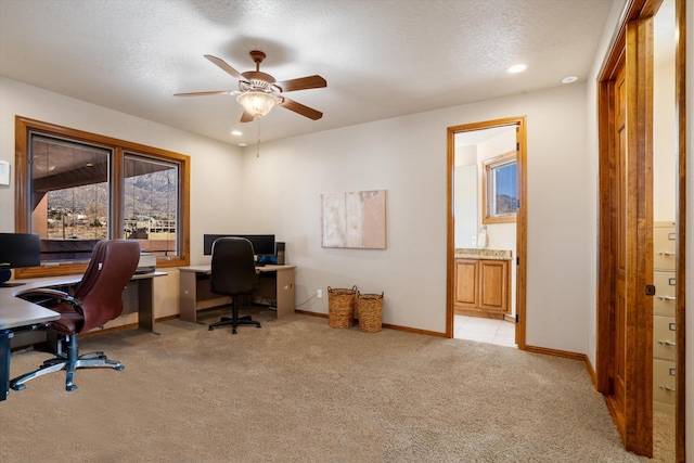 office featuring recessed lighting, light colored carpet, a ceiling fan, a textured ceiling, and baseboards