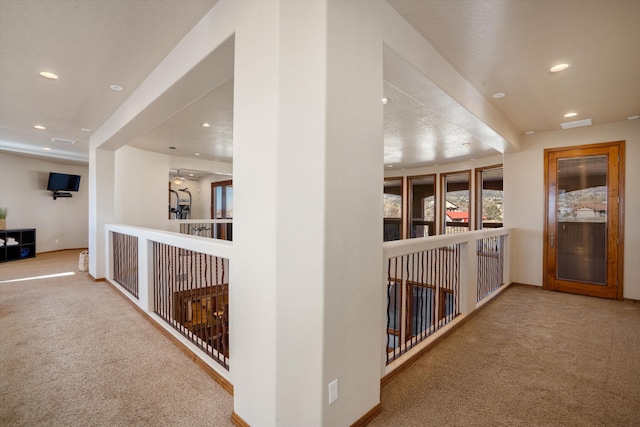 corridor featuring carpet, baseboards, and recessed lighting