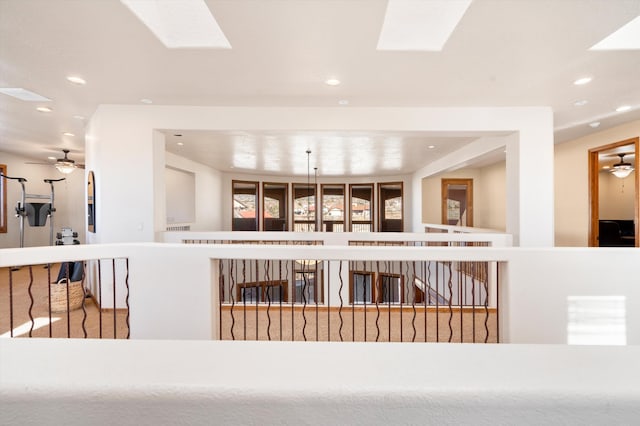 interior space featuring a skylight, a ceiling fan, and recessed lighting