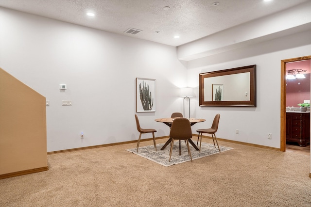 carpeted dining room featuring recessed lighting, visible vents, a textured ceiling, and baseboards