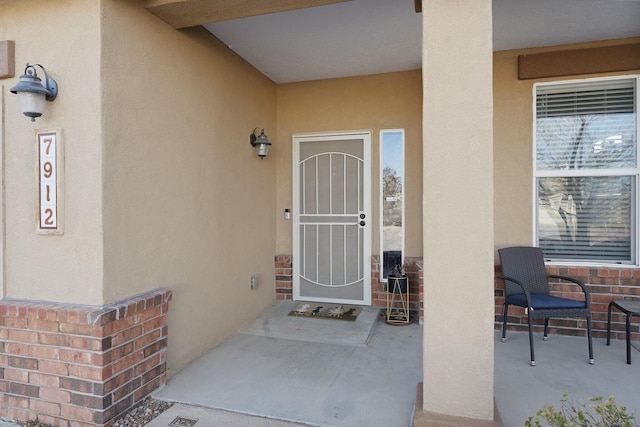 property entrance featuring a patio area