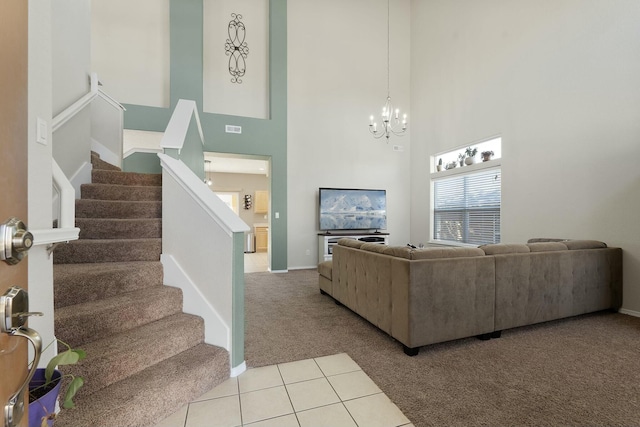 carpeted living room featuring a chandelier and a towering ceiling