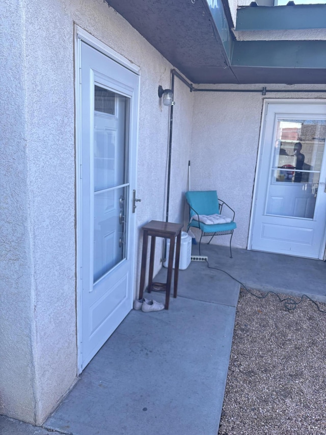 entrance to property with stucco siding