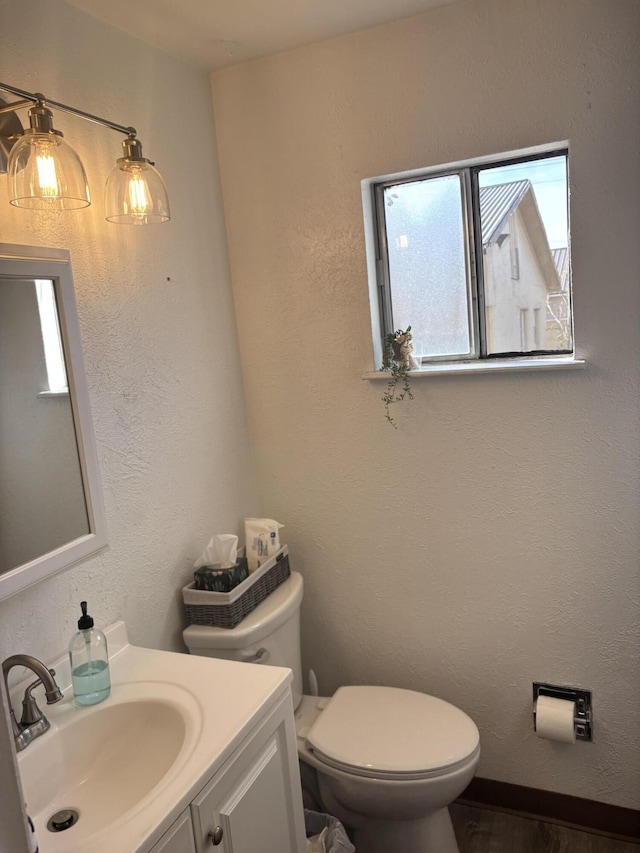 bathroom featuring vanity and toilet