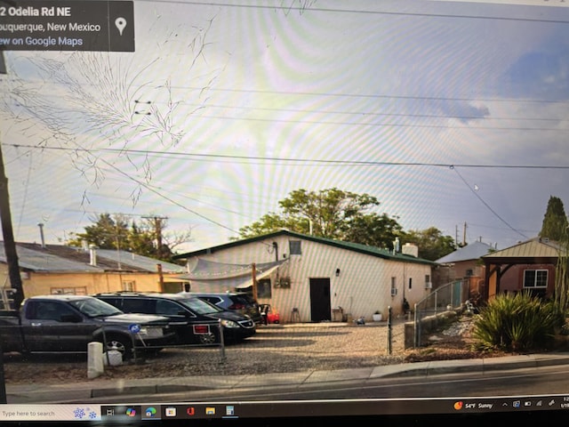 view of front of property featuring fence