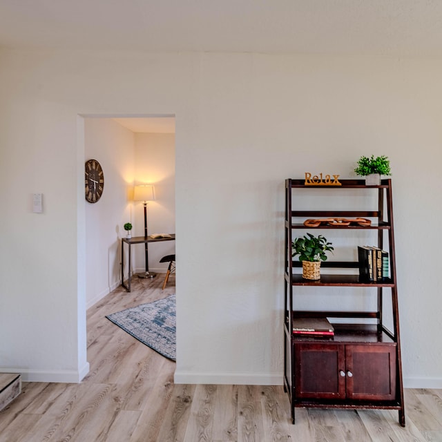 hall with wood finished floors and baseboards