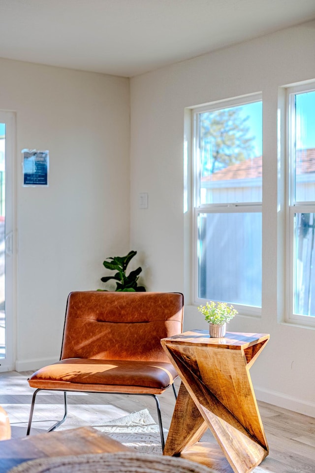 sitting room with light wood-style flooring and baseboards