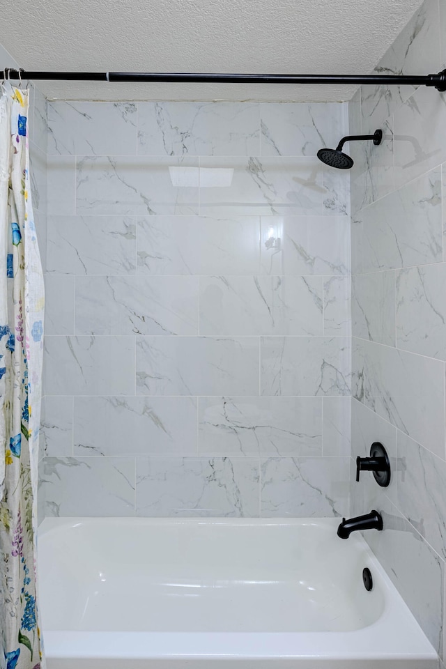 full bathroom featuring a textured ceiling and shower / bath combo with shower curtain