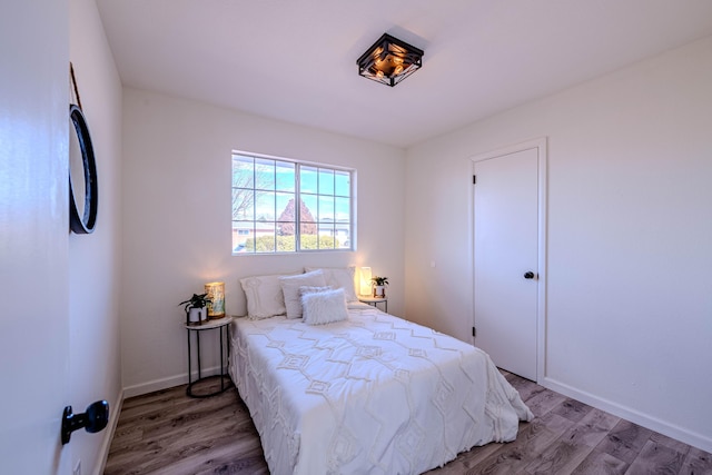 bedroom with light wood-style floors and baseboards