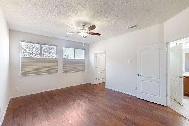 empty room featuring hardwood / wood-style floors, a textured ceiling, and ceiling fan