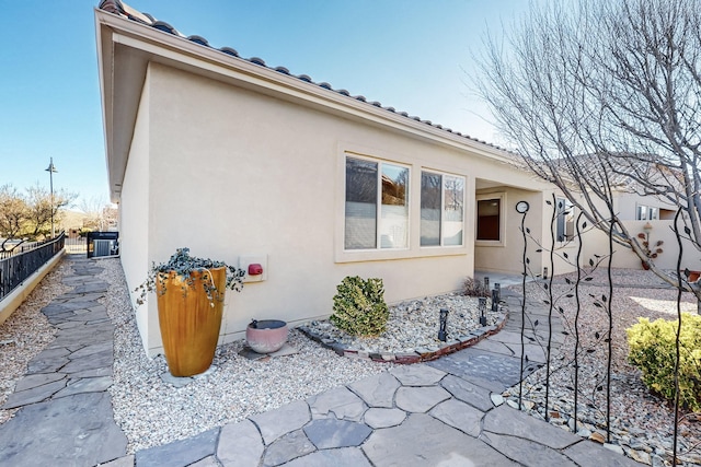 view of home's exterior with central AC and a patio area