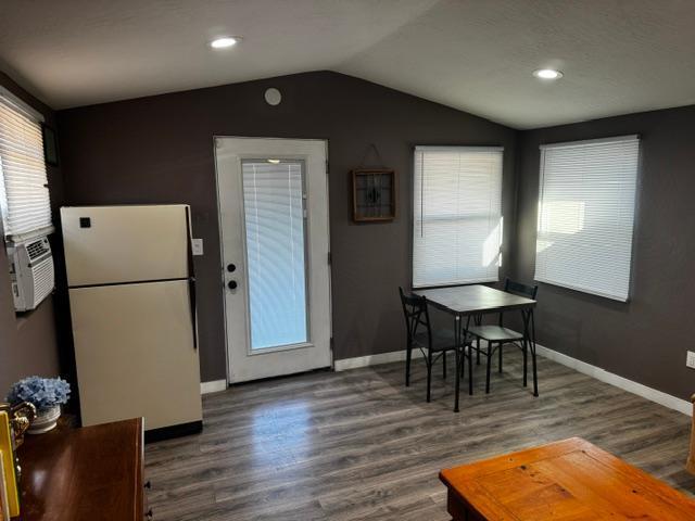 dining space with lofted ceiling and dark hardwood / wood-style floors