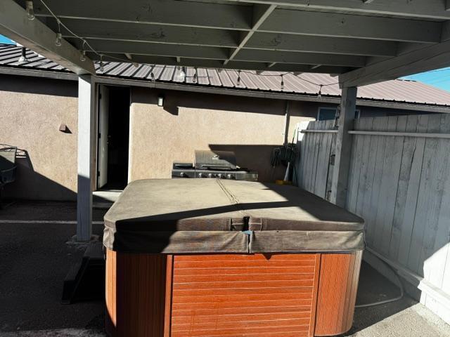 view of patio / terrace with a hot tub