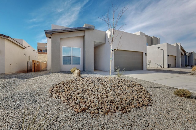 pueblo revival-style home featuring a garage