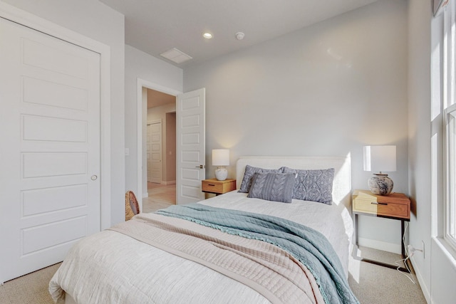 carpeted bedroom featuring baseboards and recessed lighting