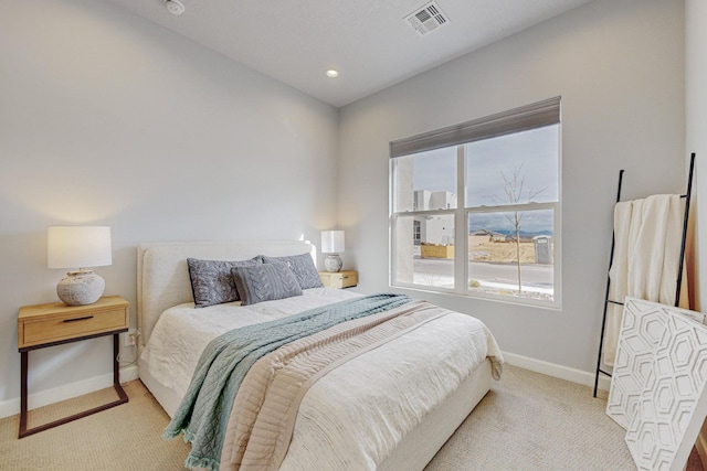 bedroom featuring light carpet