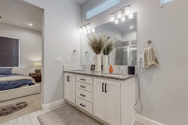 bathroom with vanity and a shower with shower door