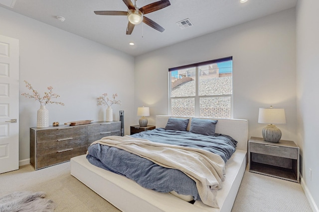 bedroom with ceiling fan and light colored carpet