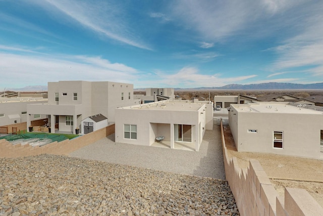 rear view of property featuring a mountain view and a patio area