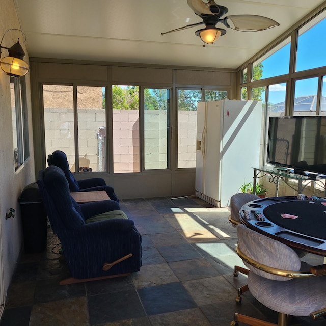 sunroom featuring ceiling fan and a healthy amount of sunlight