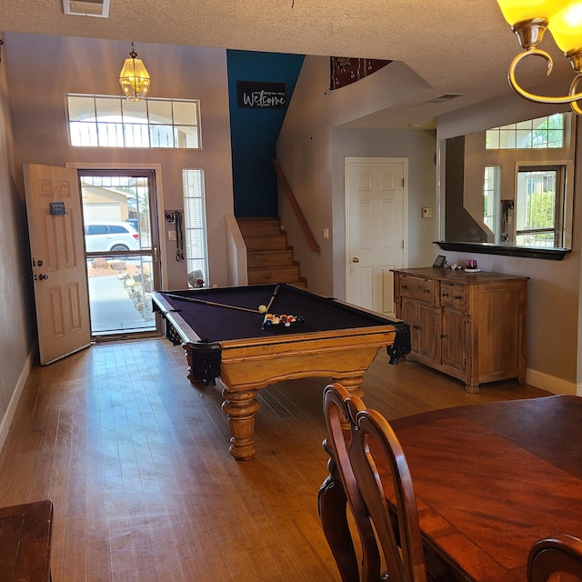 playroom featuring pool table, light hardwood / wood-style floors, and a textured ceiling