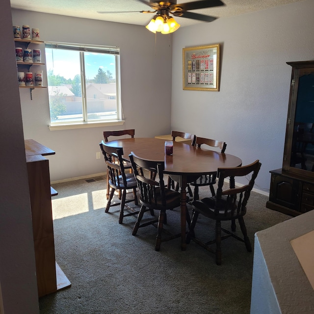 dining area featuring carpet and ceiling fan